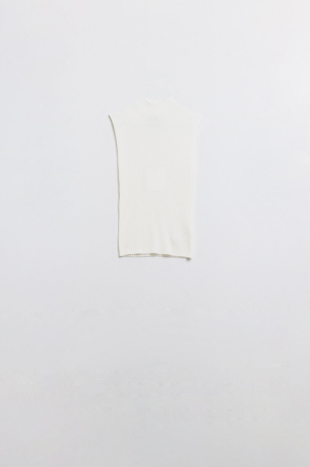 Sleeveless high neck wool jumper in white with fine knit texture and ribbed edges