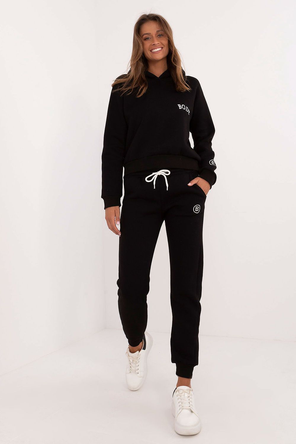 Factory Price black women's tracksuit set with hoodie and jogger pants styled with white sneakers