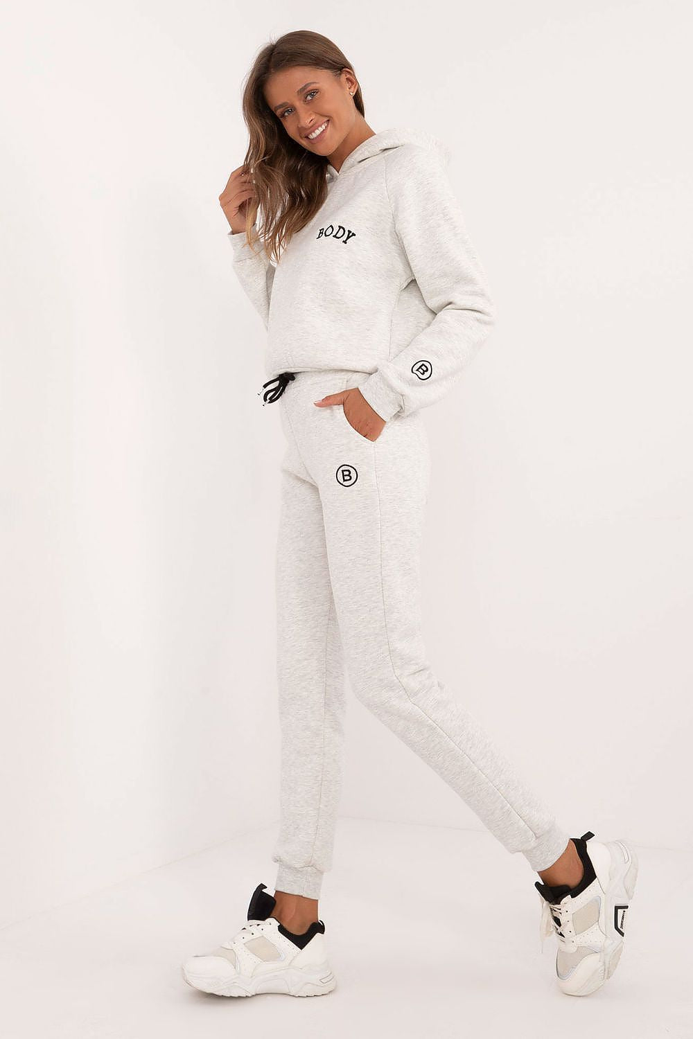 Factory Price women's tracksuit set in light gray with hoodie and jogger pants worn with white sneakers