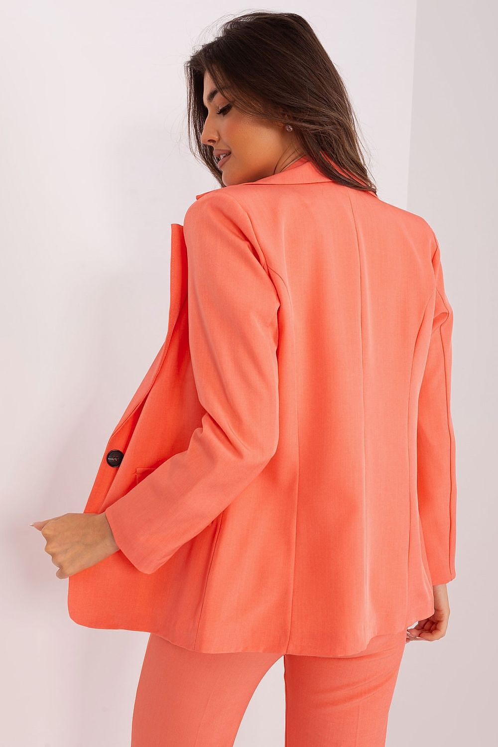 Women wearing a coral casual elegant blazer for women by Italy Moda shown from the back
