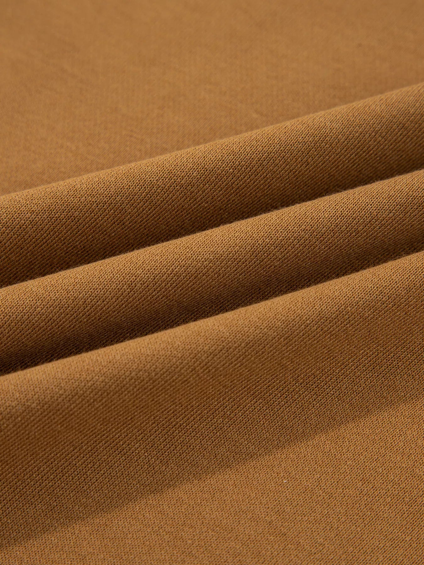 Close-up of the fabric texture of an Oversized Textured Split Neck High Low Sweatshirt in rich brown colour