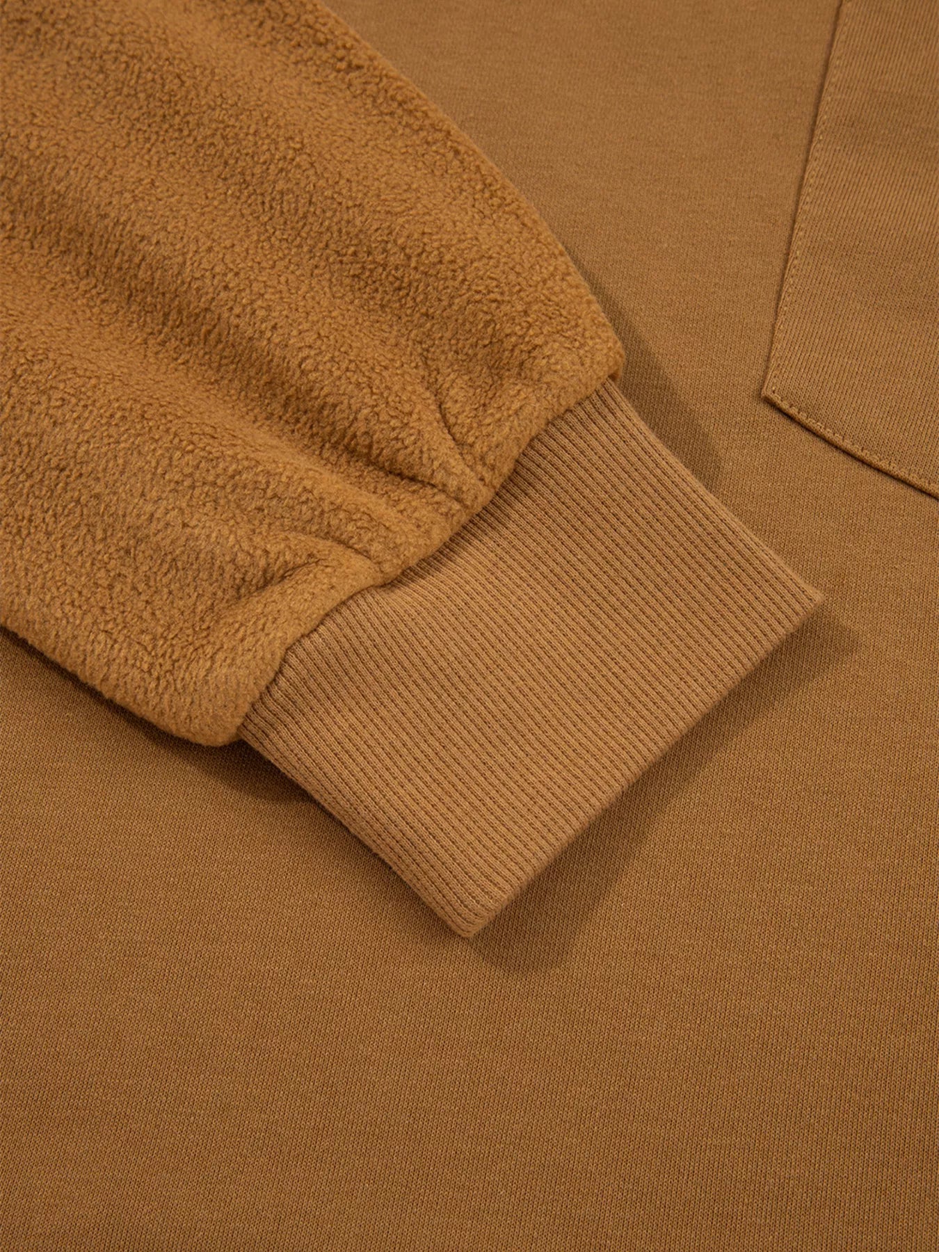 Close-up of an Oversized Textured Split Neck High Low Sweatshirt with soft sleeve detailing