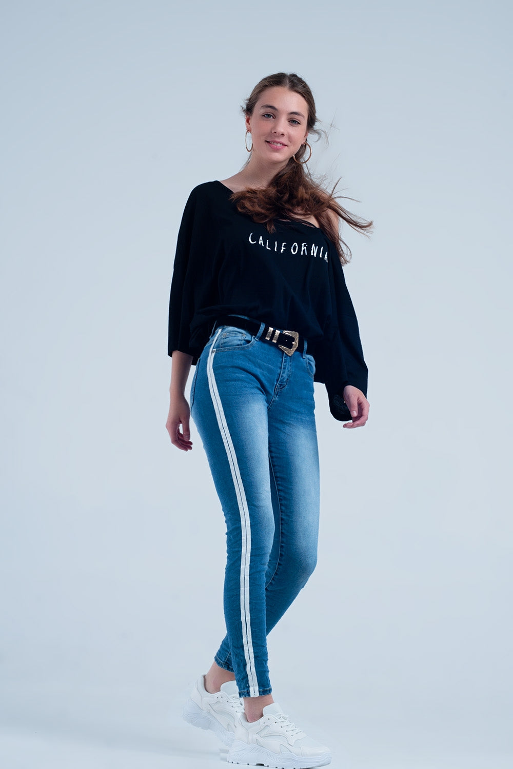 Calça jeans skinny com listra lateral branca