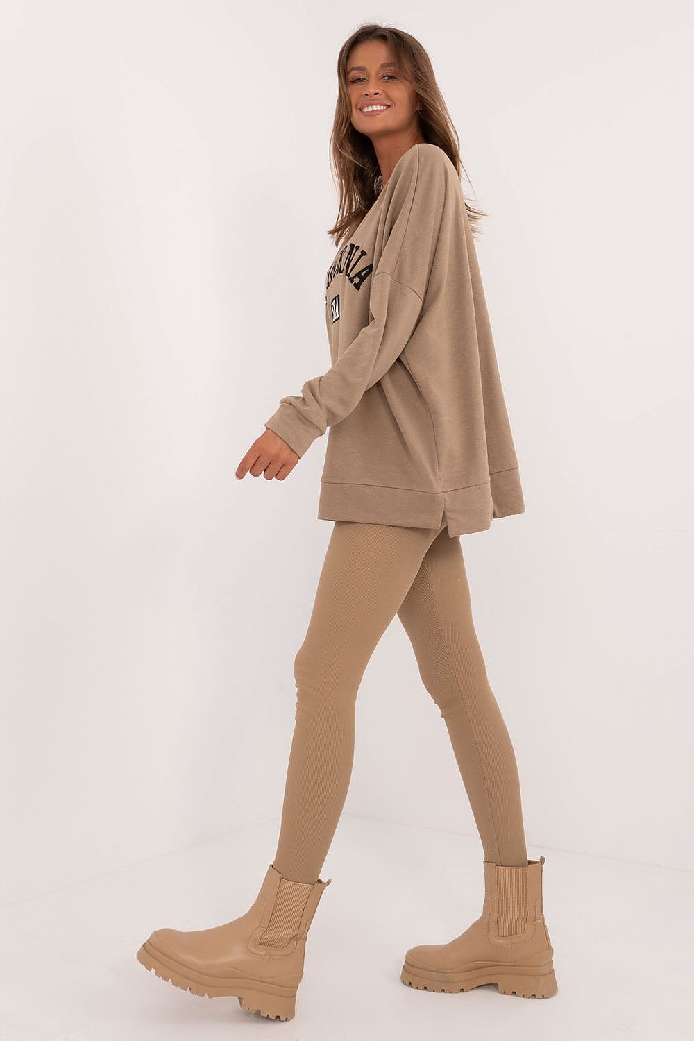 Woman wearing Factory Price oversized sweatshirt and leggings set in beige with matching boots