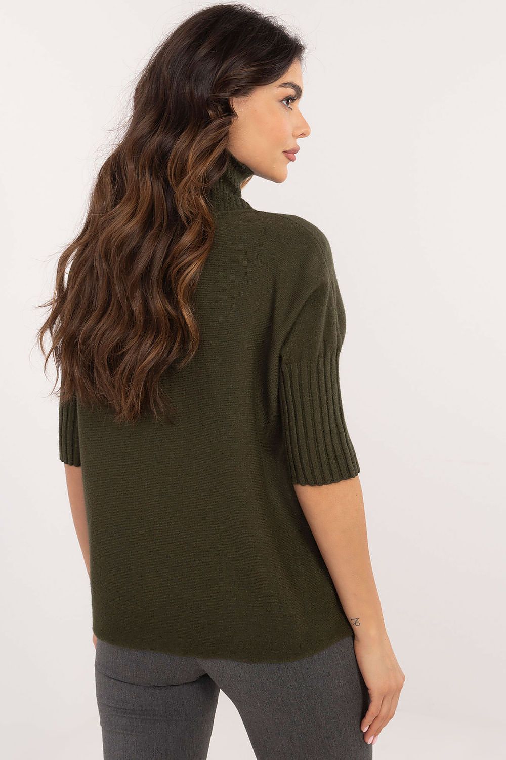 BFG short sleeve turtle neck sweater in dark green knitwear worn by woman viewed from the back