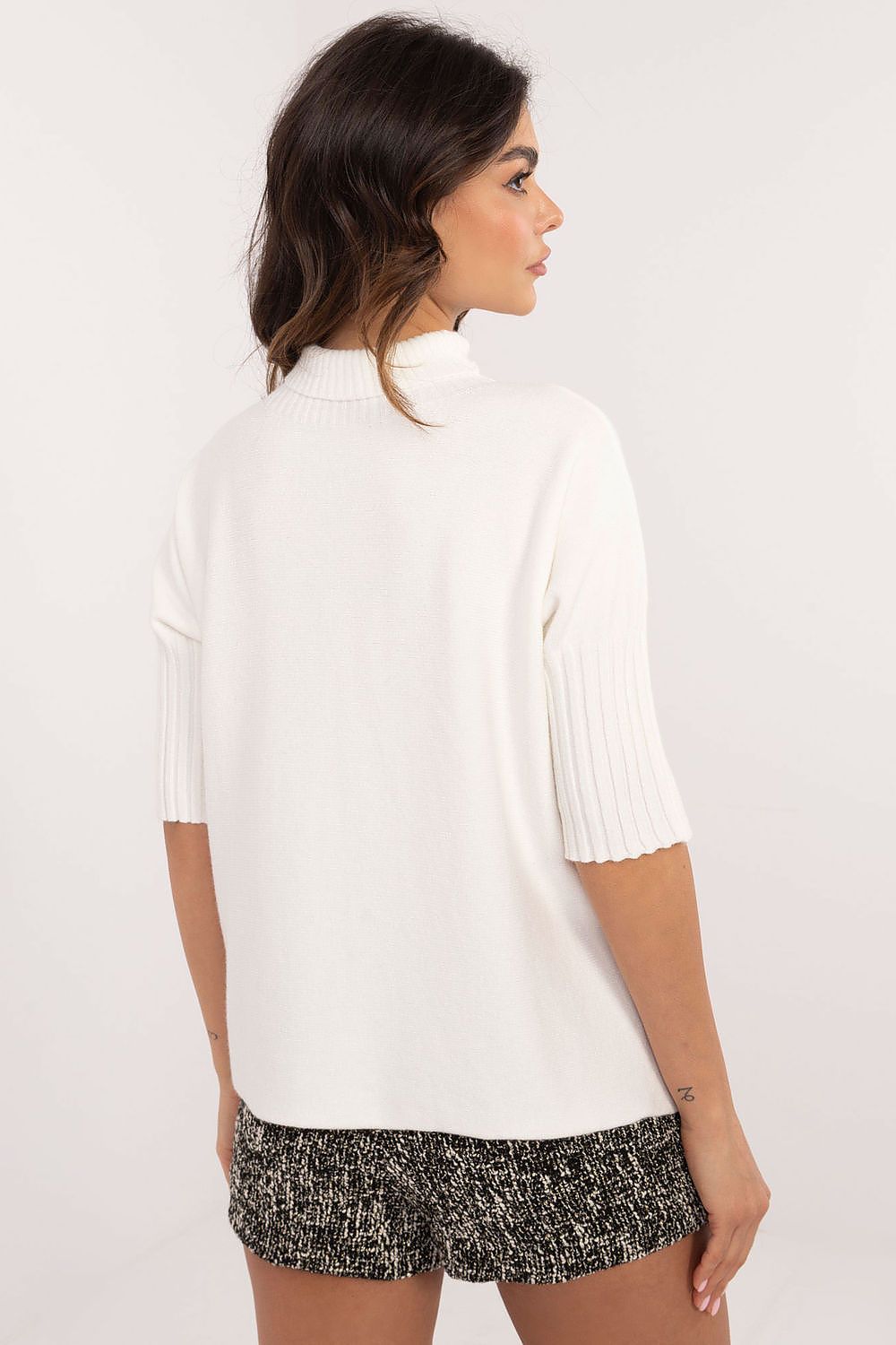 BFG white short sleeve turtle neck sweater with ribbed sleeves on female model from back