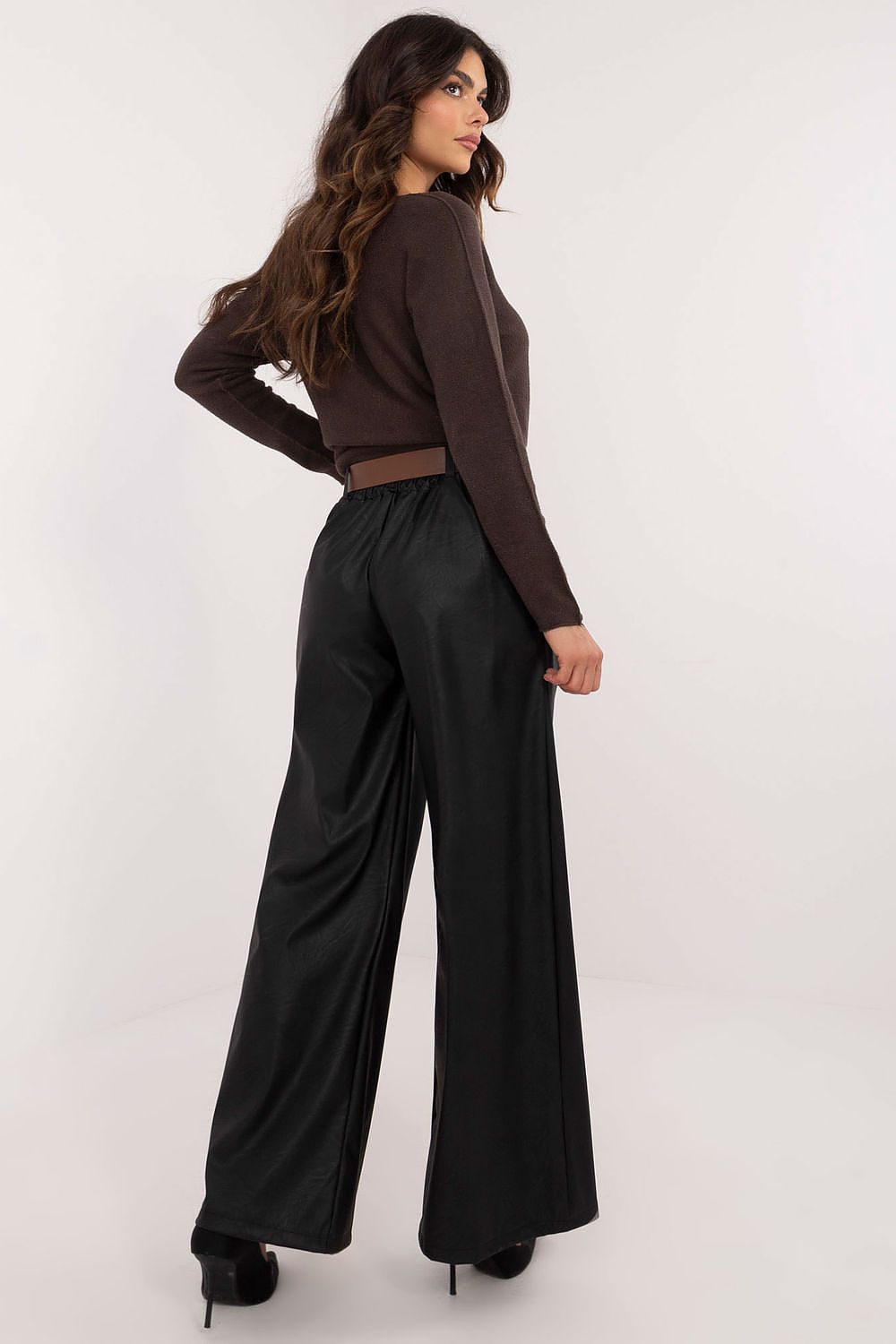 Woman wearing Italy Moda wide leg faux leather trousers paired with a brown long sleeve top