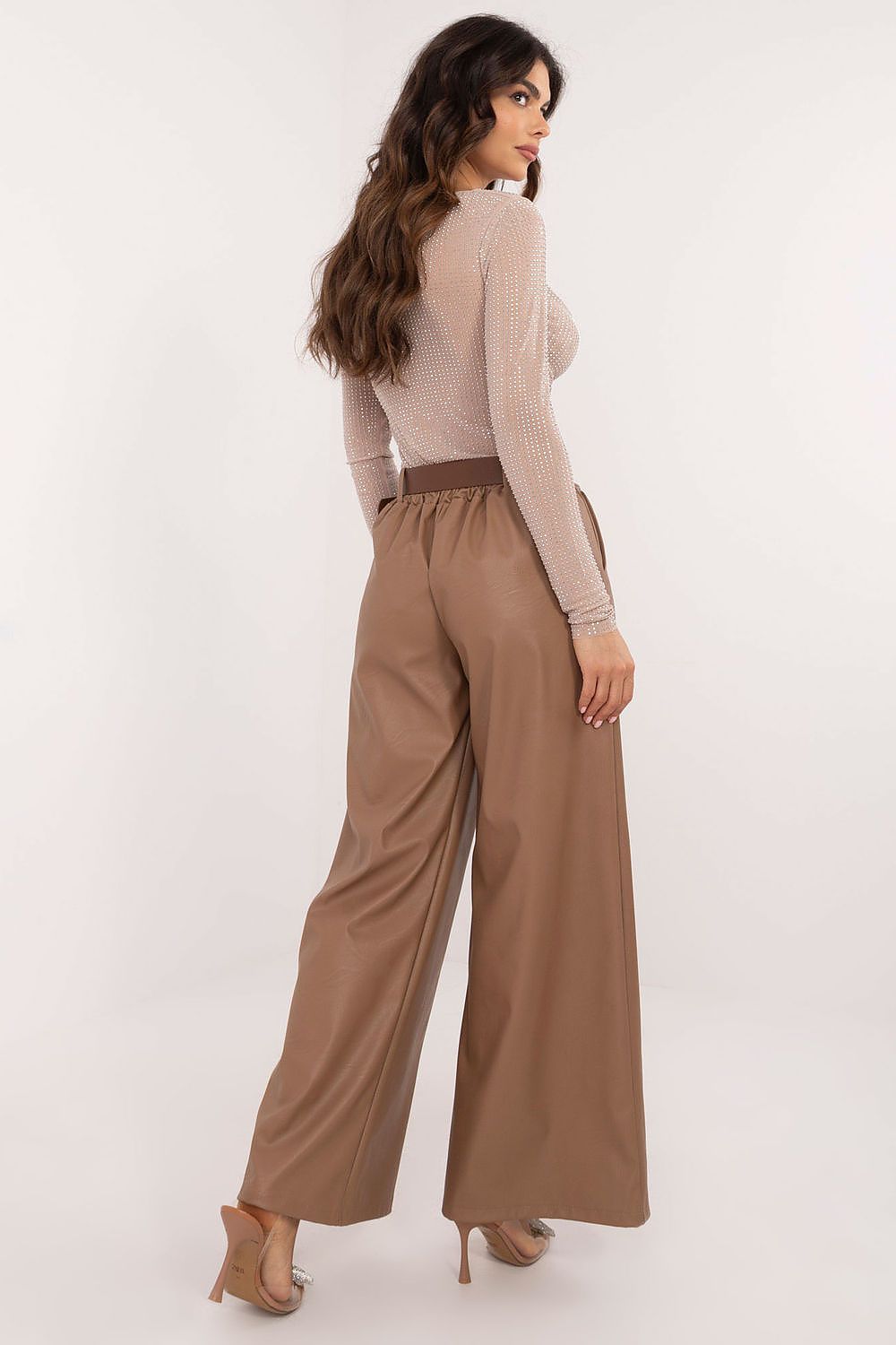 Woman wearing brown wide leg faux leather trousers by Italy Moda with high waist and relaxed fit