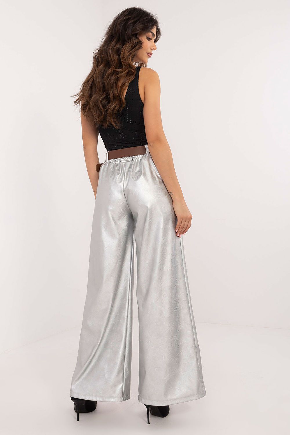Italy Moda wide leg faux leather trousers in shiny silver worn by model with black top and heels