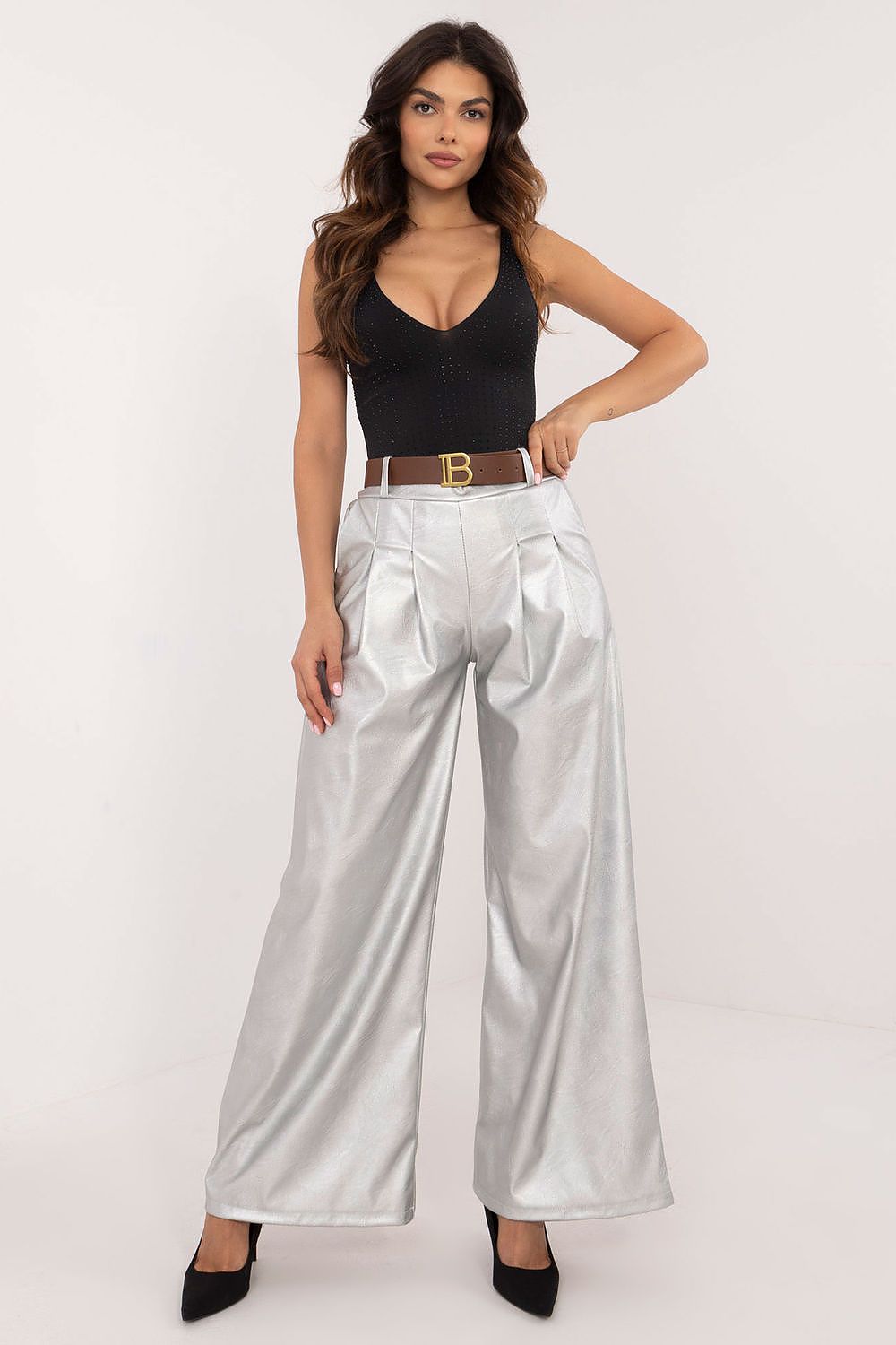 Woman wearing silver wide leg faux leather trousers from Italy Moda paired with a black sleeveless top