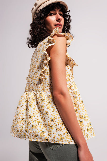 Blusa amarela com bordados e detalhes de rufos