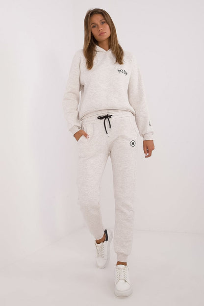 Factory Price women's tracksuit set in light gray with hoodie and jogger pants paired with white sneakers