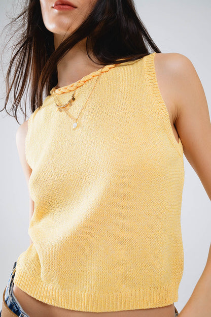 Camisola amarela sem mangas com decote em gola alta e detalhes de tranças no decote
