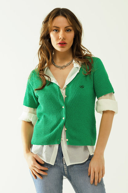 Q2 Casaco de malha verde com mangas curtas e fecho frontal com b