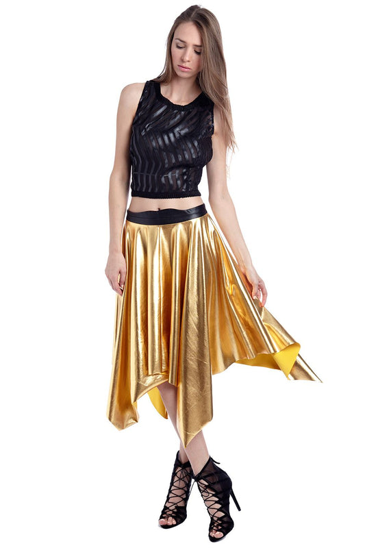 Gold pleated midi skirt with asymmetric hem worn with black sleeveless top and lace-up heels