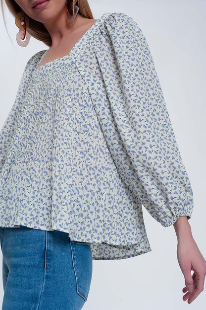 Top floral azul com decote quadrado e mangas insufláveis