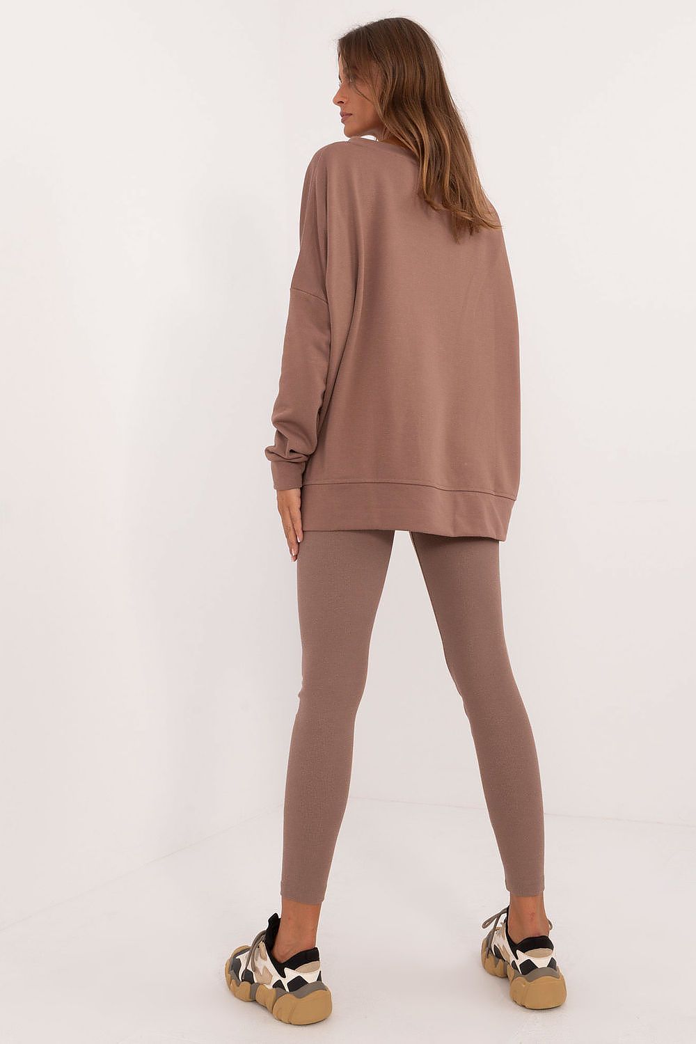 Woman wearing brown oversized sweatshirt and leggings set from Factory Price standing with back view