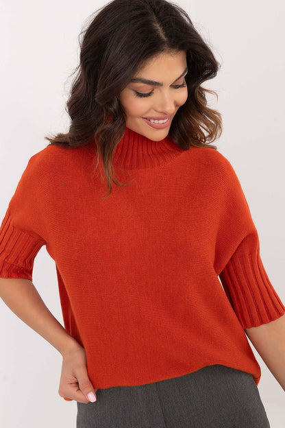 BFG orange short sleeve turtle neck sweater worn by woman with dark wavy hair