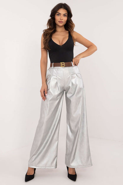 Woman wearing silver wide leg faux leather trousers from Italy Moda paired with a black sleeveless top